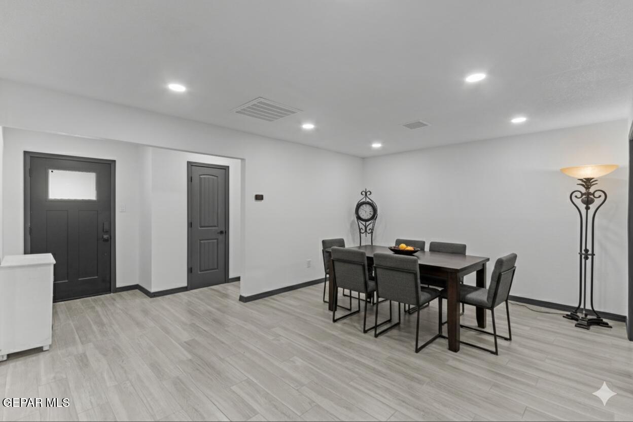 3425 Rutherglen Street El Paso, TX 79925 - Photo 13 of 34 a view of a dining room with furniture and wooden floor