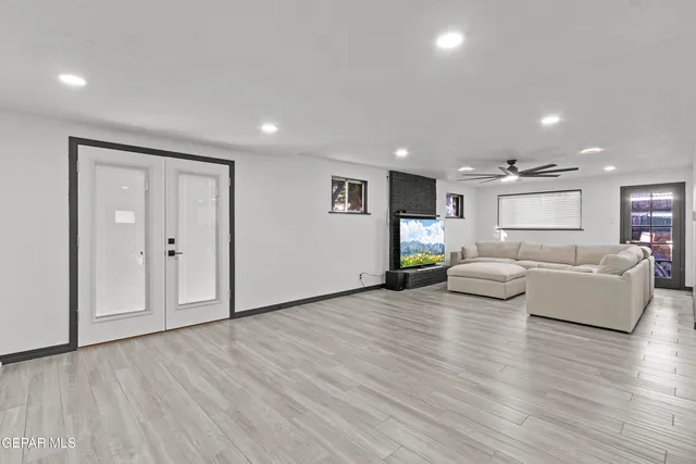 a living room with furniture and wooden floor