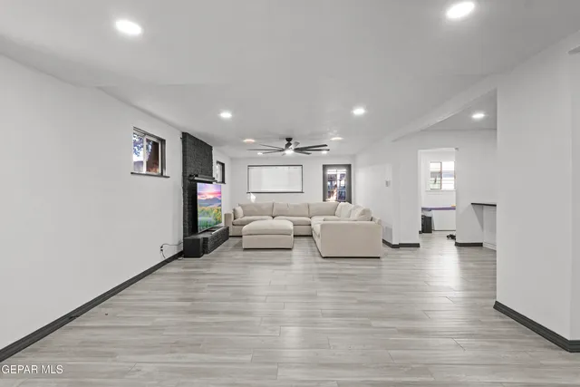a living room with furniture and a wooden floor