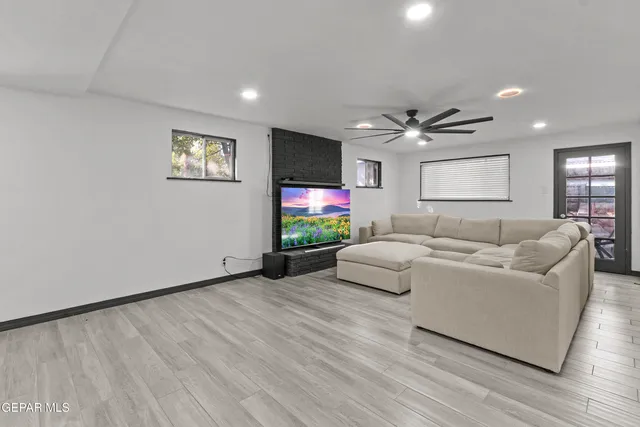 a living room with furniture and a flat screen tv