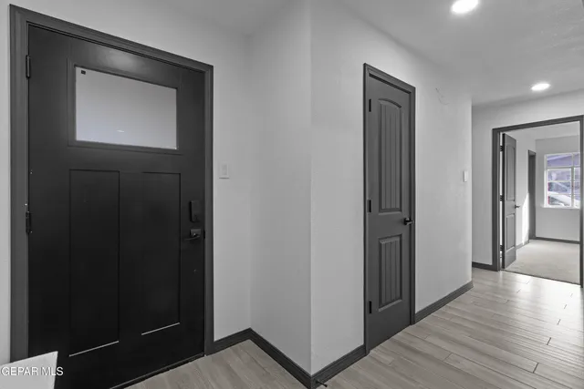 a view of hallway with wooden floor