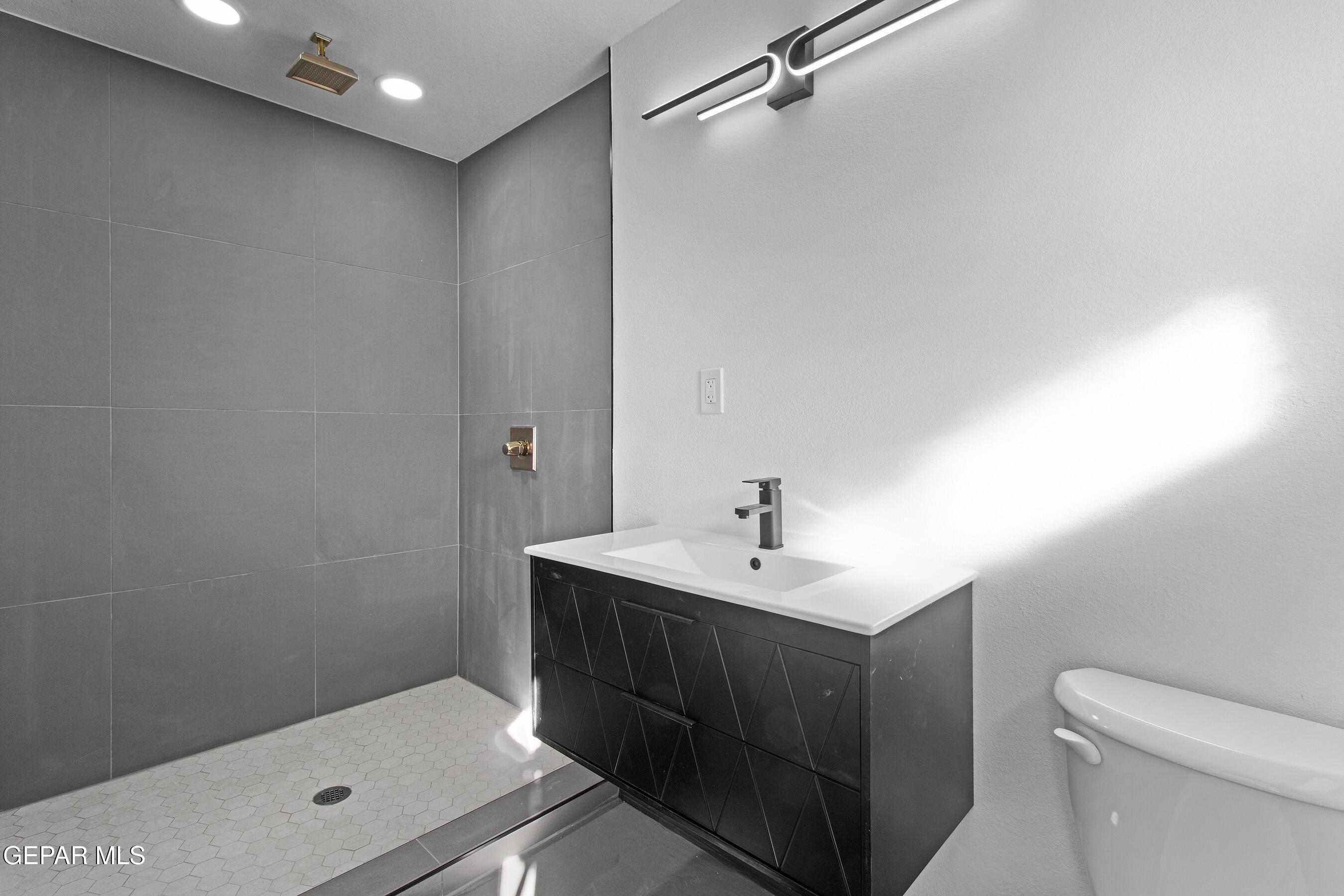 3425 Rutherglen Street El Paso, TX 79925 - Photo 23 of 34 a bathroom with a sink a toilet and shower