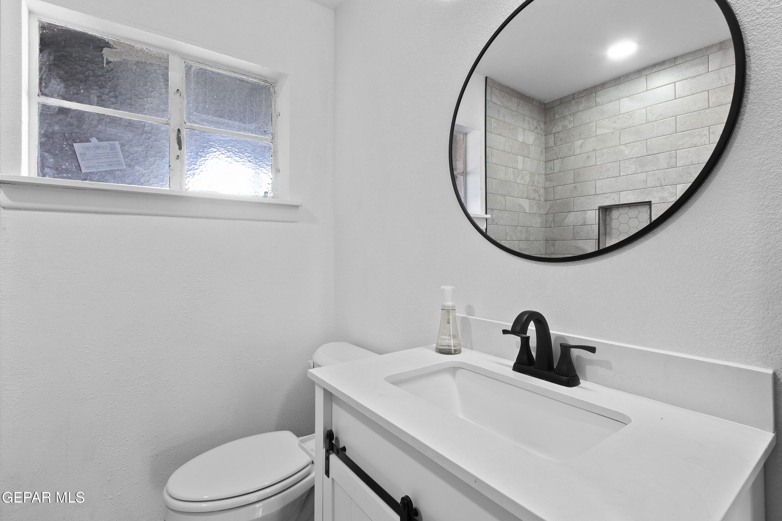 3425 Rutherglen Street El Paso, TX 79925 - Photo 26 of 34 a bathroom with a toilet a sink and mirror