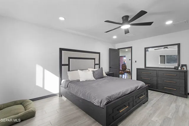 a bedroom with a large bed and a chandelier