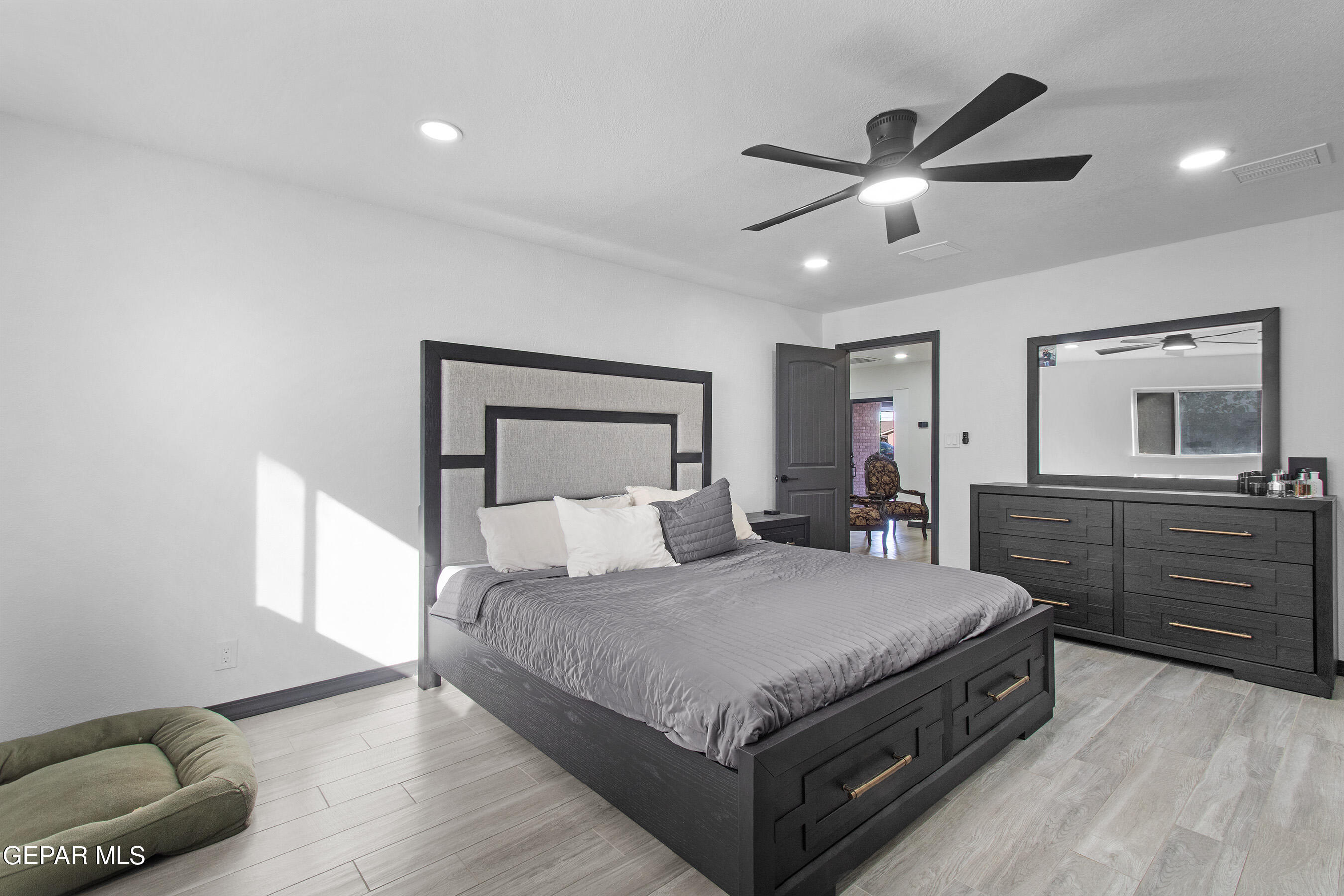 3425 Rutherglen Street El Paso, TX 79925 - Photo 28 of 34 a bedroom with a large bed and a chandelier