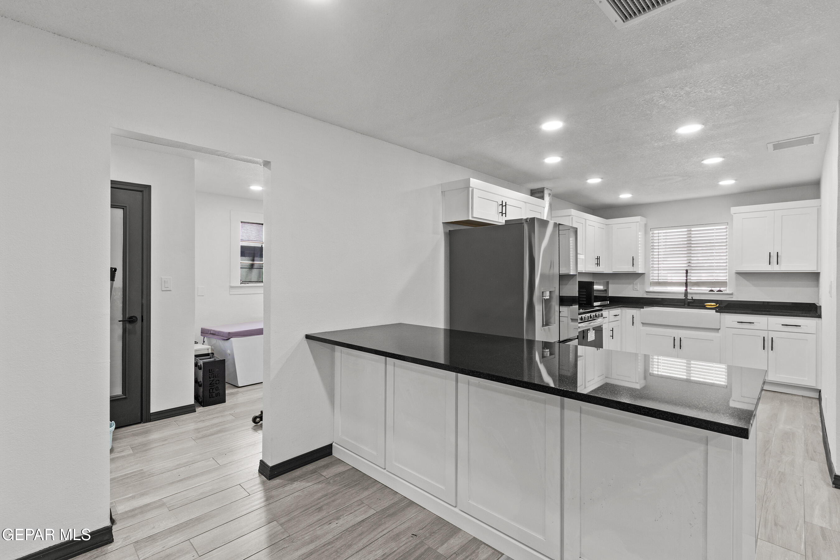 3425 Rutherglen Street El Paso, TX 79925 - Photo 6 of 34 a kitchen with refrigerator and cabinets