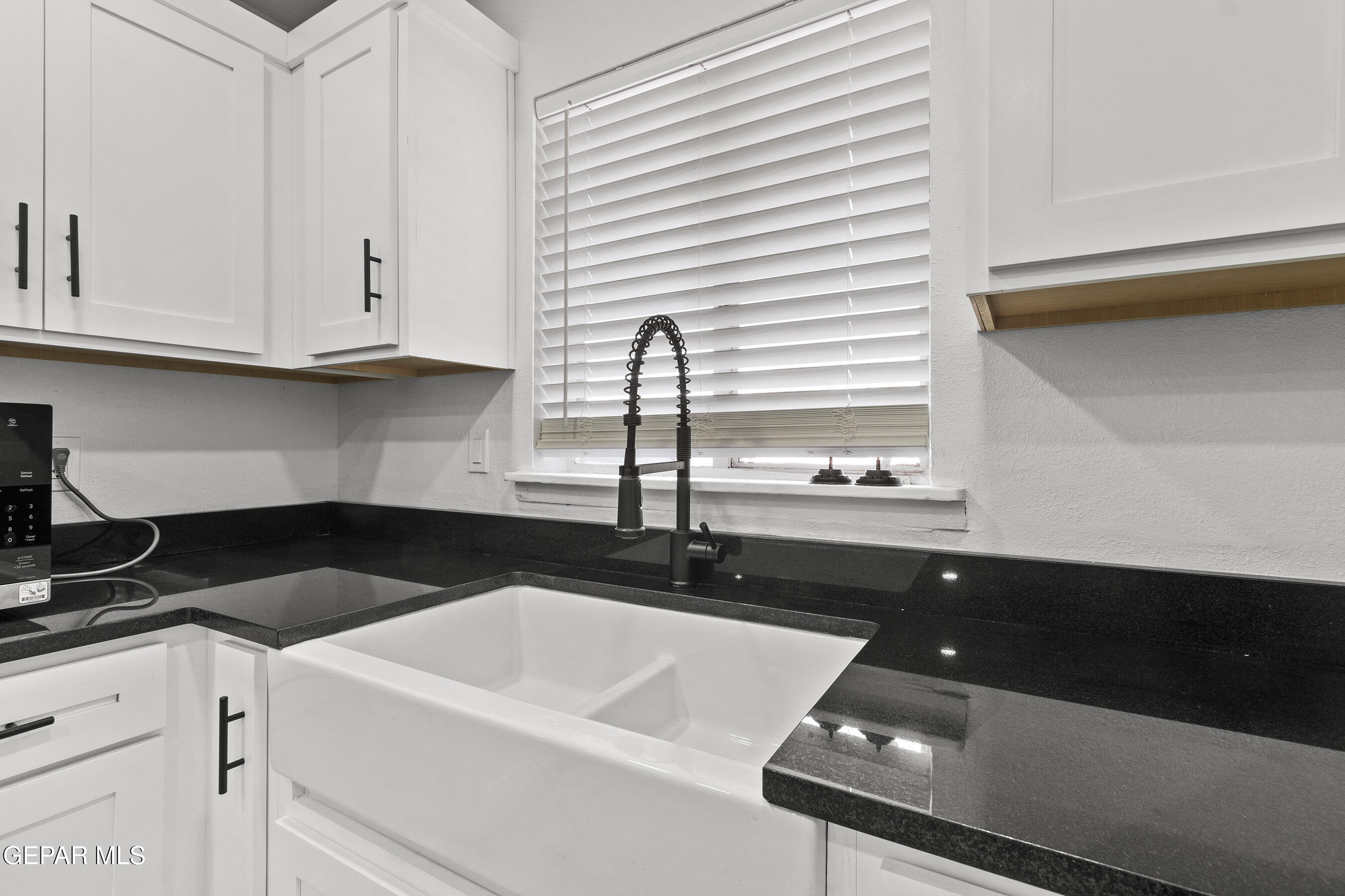 3425 Rutherglen Street El Paso, TX 79925 - Photo 10 of 34 a kitchen with a sink and cabinets