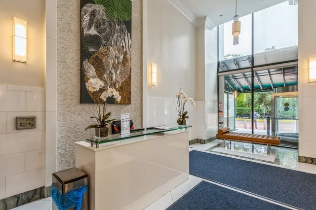 a bedroom with large window and a bed