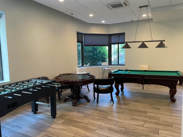 a view of a workspace with furniture and window