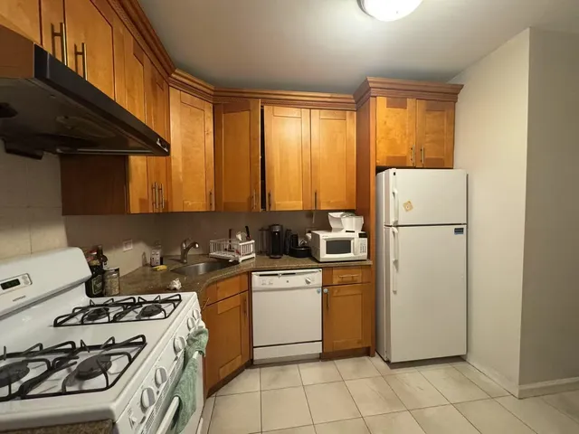 a kitchen with a stove a refrigerator and a sink