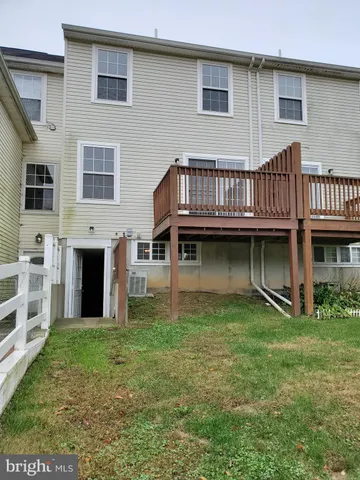 a view of a field with grass and trees in the back