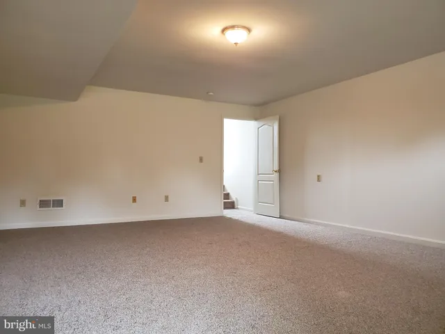 a view of an empty room and a window