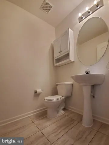 a bathroom with a sink toilet and a mirror