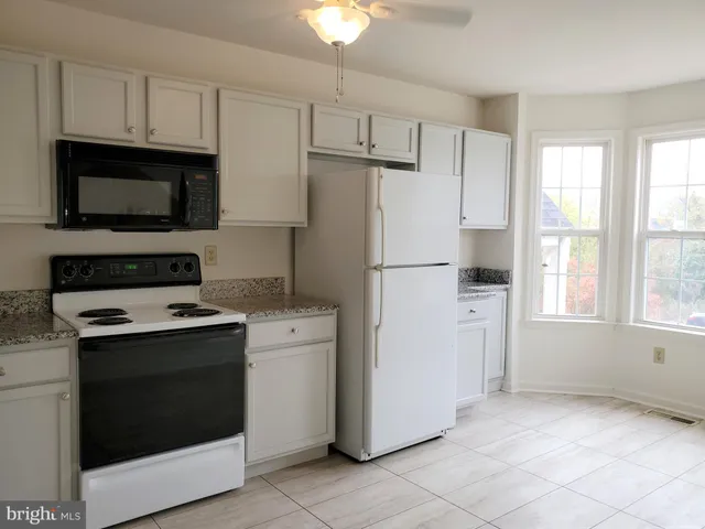 a kitchen with cabinets and steel stainless steel appliances