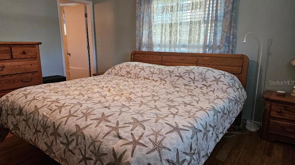 4600 98th Way North, Unit 210 St. Petersburg, FL 33708 - Photo 14 of 33 a bedroom with a bed and a window