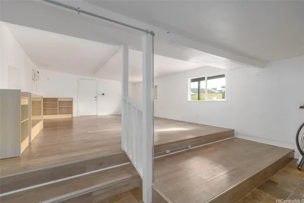 a view of a hallway view with wooden floor and staircase