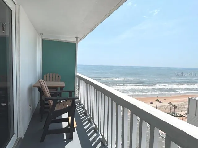 a view of a balcony with chair and table