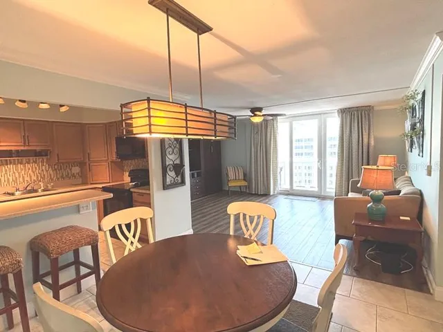 a dining room with furniture and wooden floor