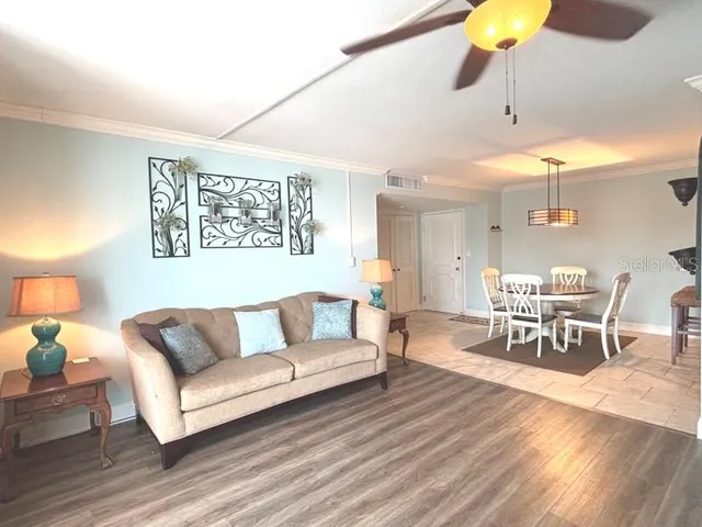 a living room with furniture and a wooden floor