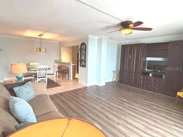 a living room with furniture and a wooden floor