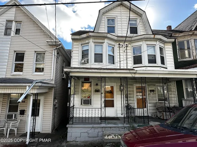 a living room with furniture and a ceiling fan