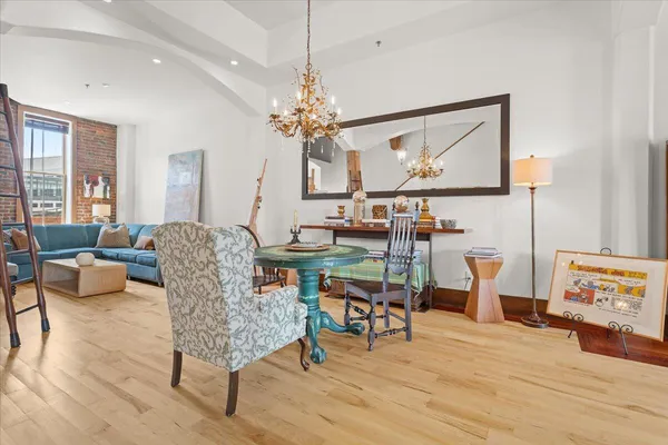 a living room with furniture and a chandelier