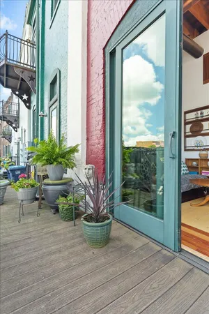 a view of a fountain with potted plants in front of it