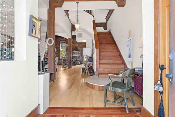 a view of hall way with furniture and stairs