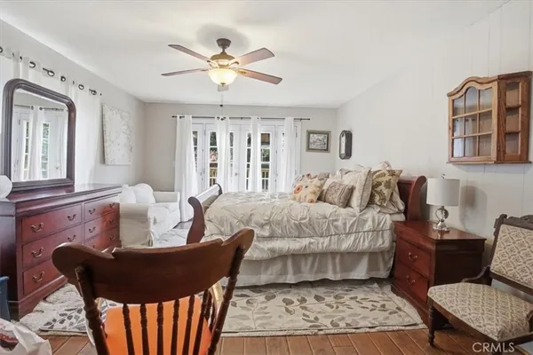 a spacious bedroom with a bed and a chandelier