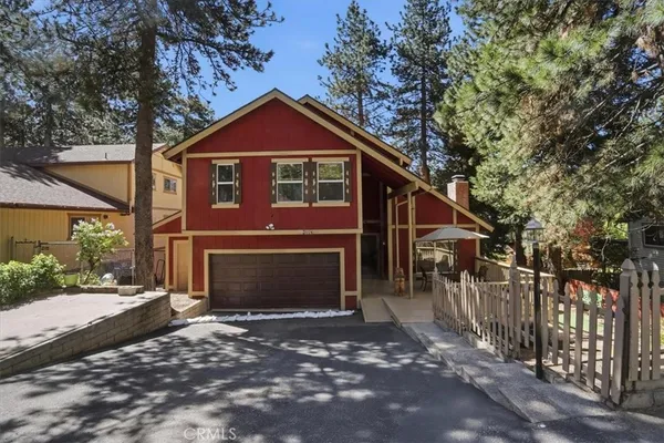 a living room with furniture a fireplace and a floor to ceiling window