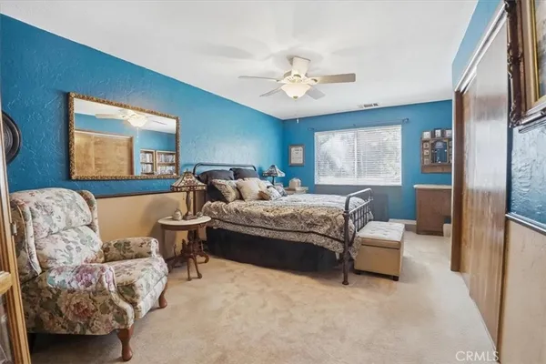 a bed room with a bed and a television