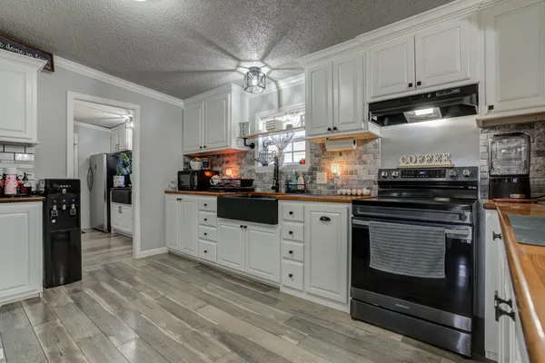 a view of a house with wooden deck and furniture