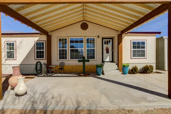a front view of a building with large trees