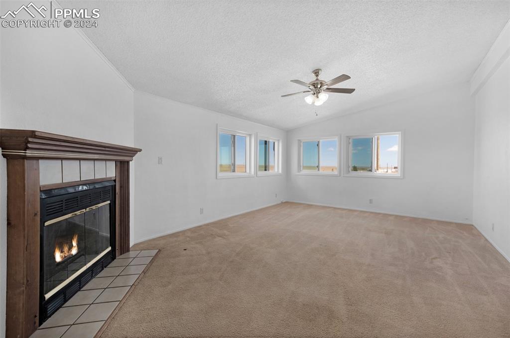 33510 Fossinger Road Yoder, CO 80864 - Photo 21 of 50 a view of an empty room with window and fireplace
