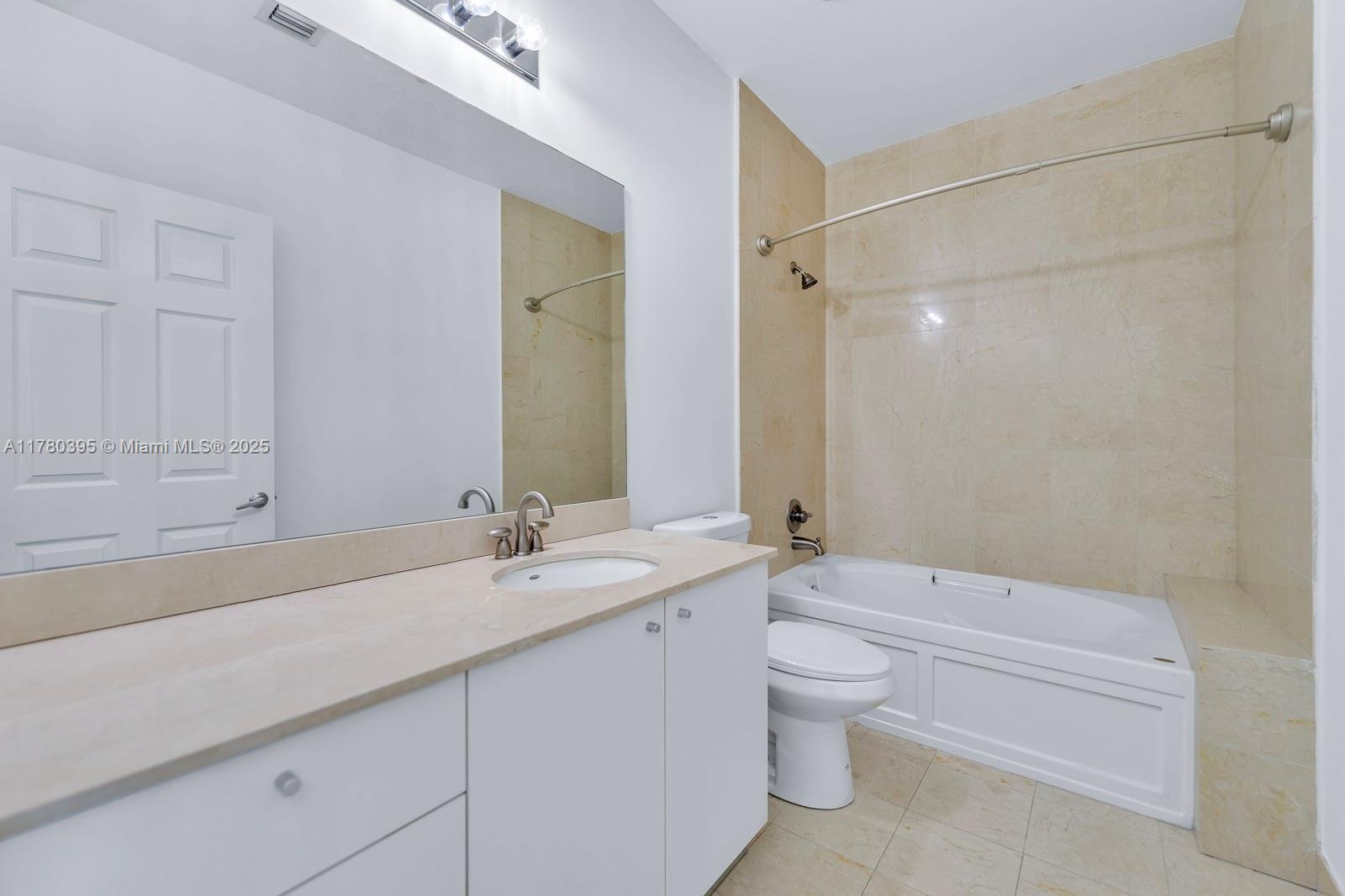 2100 Van Buren Street, Unit 206 Hollywood, FL 33020 - Photo 11 of 17 a bathroom with a granite countertop sink a toilet and a bathtub