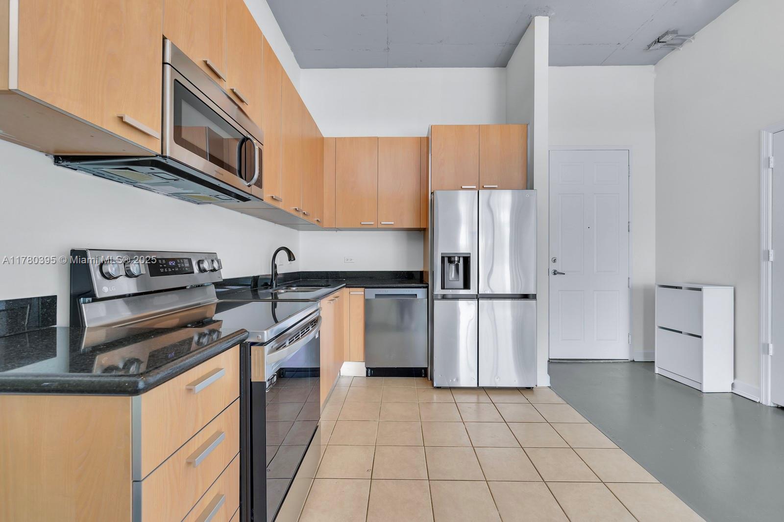 2100 Van Buren Street, Unit 206 Hollywood, FL 33020 - Photo 4 of 17 a kitchen with a stove a refrigerator and cabinets