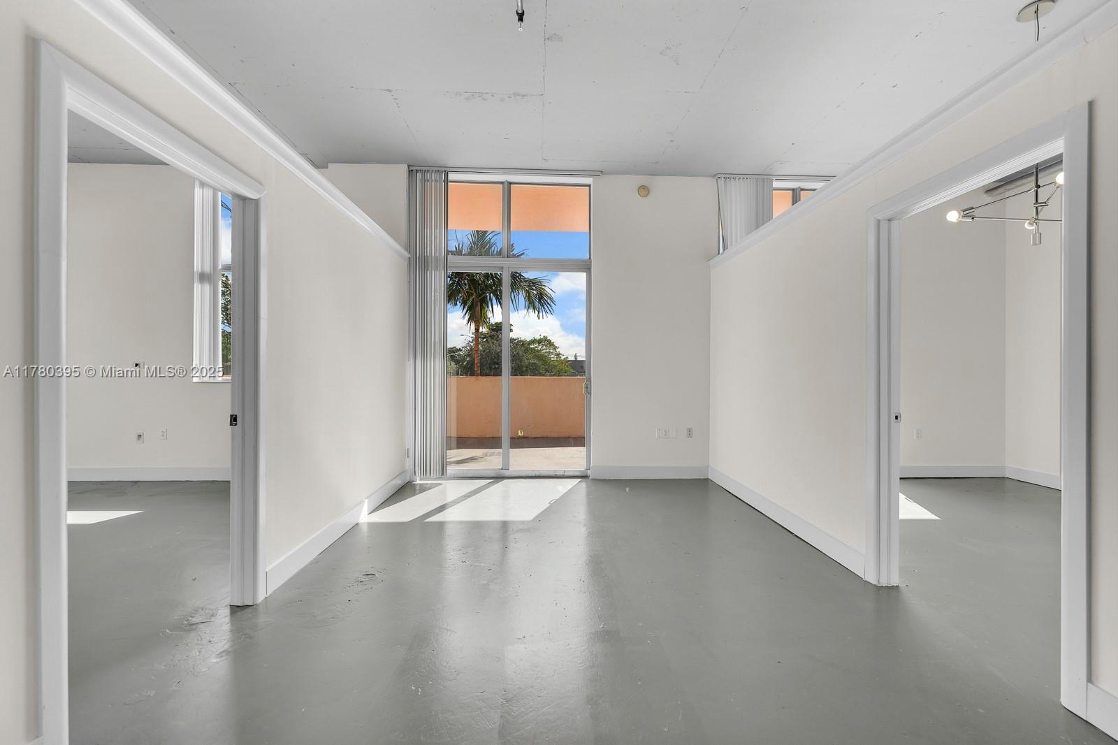 2100 Van Buren Street, Unit 206 Hollywood, FL 33020 - Photo 5 of 17 a view of an empty room with window and wooden floor