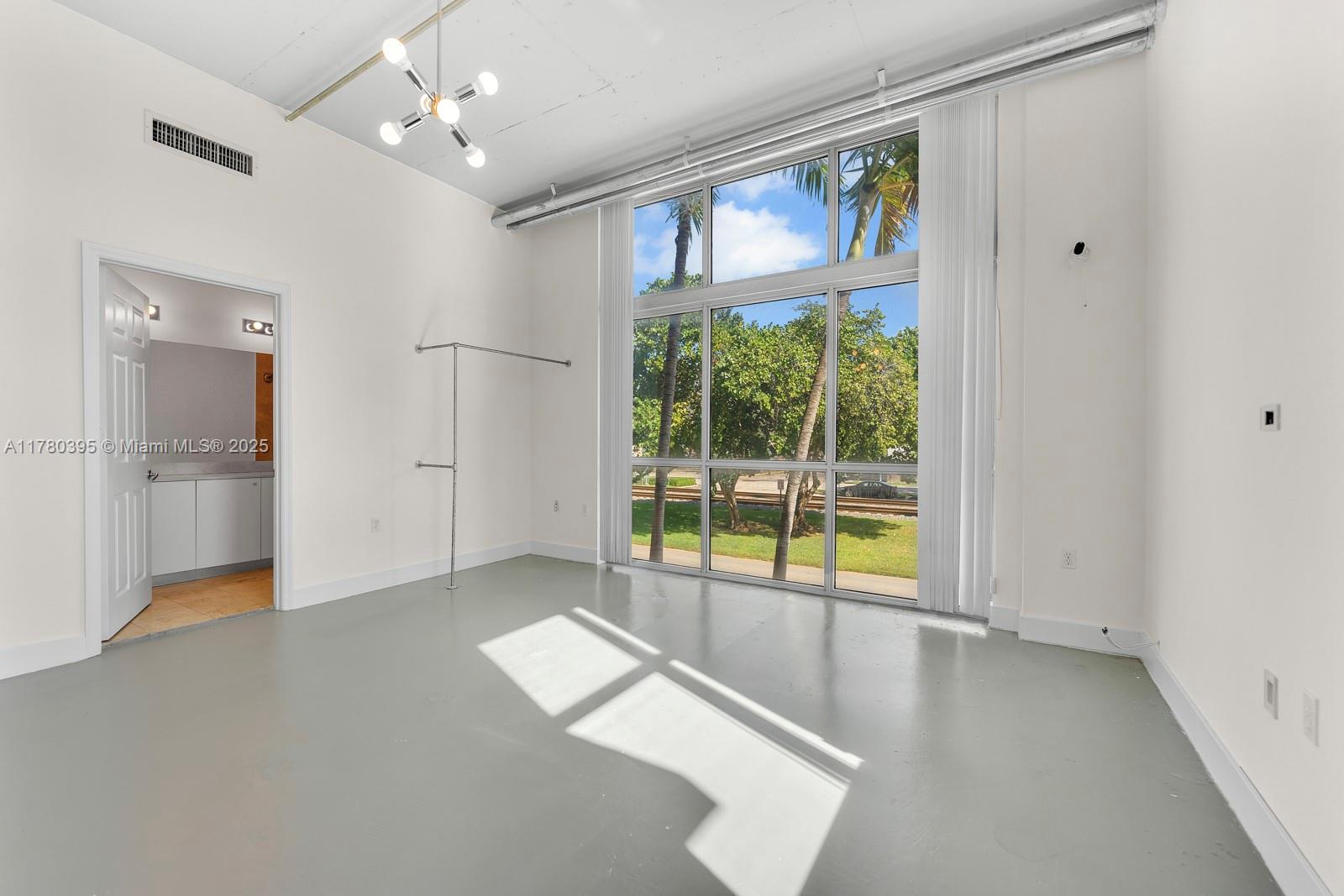 2100 Van Buren Street, Unit 206 Hollywood, FL 33020 - Photo 7 of 17 wooden floor in an empty room with a window
