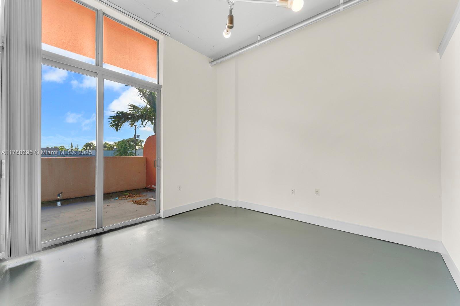 2100 Van Buren Street, Unit 206 Hollywood, FL 33020 - Photo 8 of 17 an empty room with windows