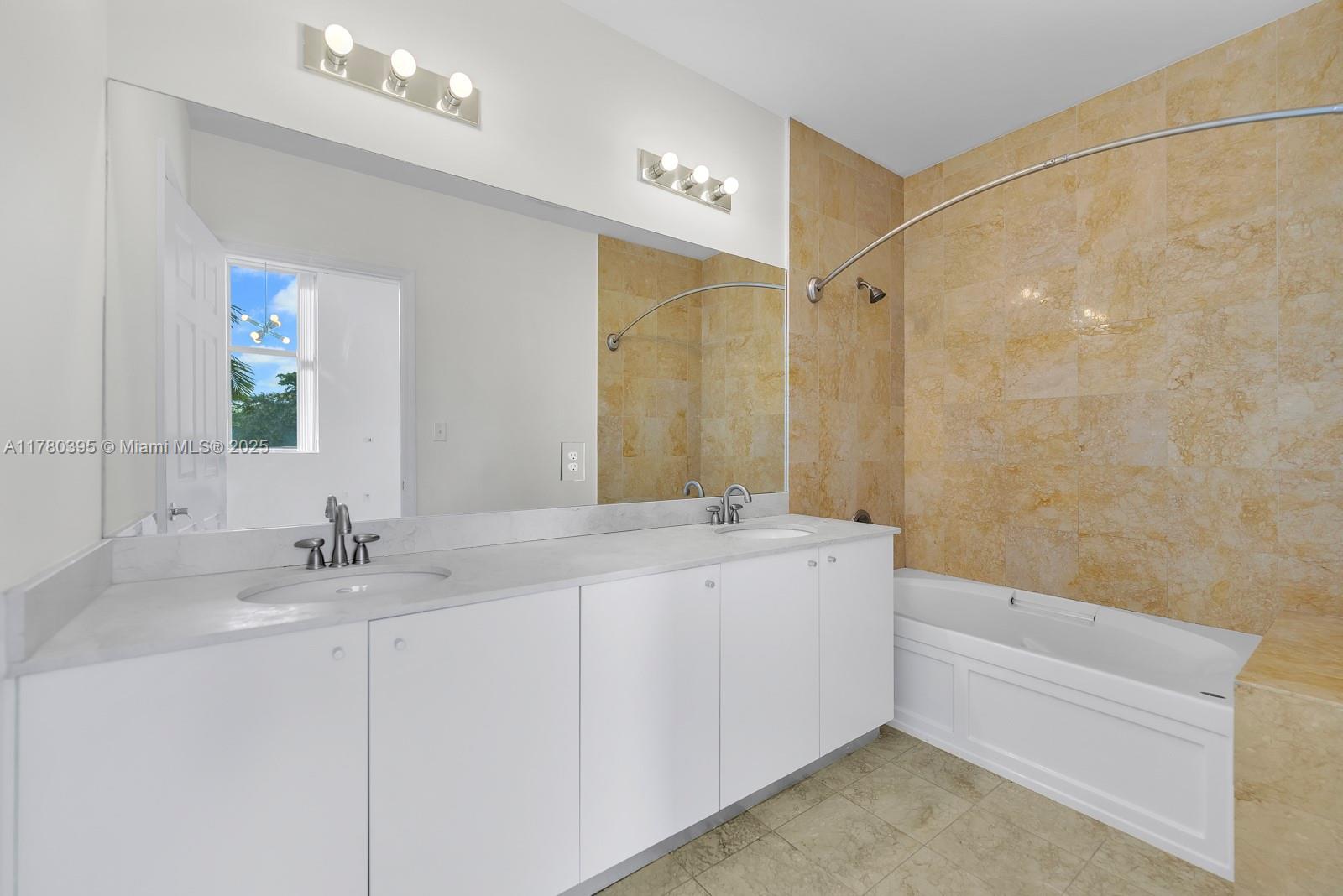2100 Van Buren Street, Unit 206 Hollywood, FL 33020 - Photo 9 of 17 a bathroom with a bathtub a sink and a mirror