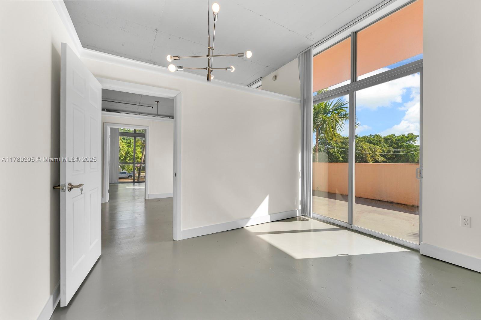 2100 Van Buren Street, Unit 206 Hollywood, FL 33020 - Photo 10 of 17 a view of a livingroom with a ceiling fan and window