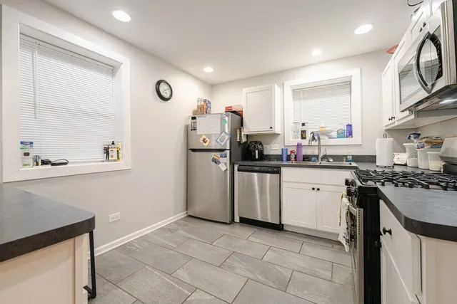 a kitchen with a sink cabinets and stainless steel appliances