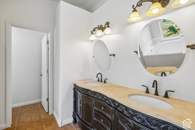 190 North 100 West Alpine, UT 84004 - Photo 17 of 31 Double vanity with decorative dark wood cabinetry, dual oval mirrors, and elegant wall-mounted lighting