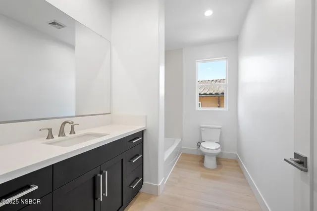 an empty room with a ceiling fan and window