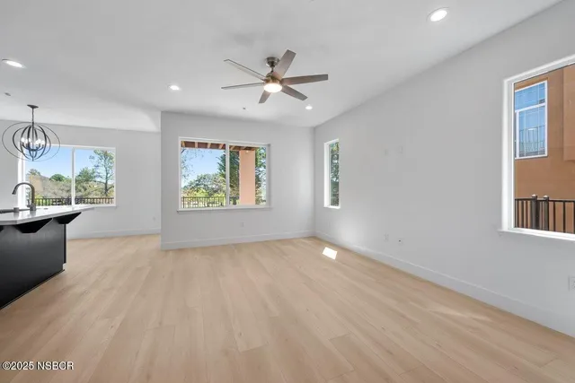 a kitchen with stainless steel appliances granite countertop a sink a stove and a refrigerator