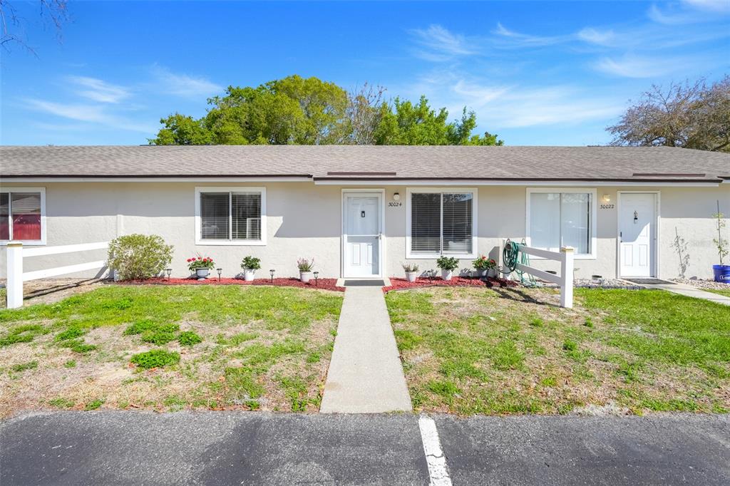 30024 Tavares Ridge Boulevard, Unit 62 Tavares, FL 32778 - Photo 1 of 31 a view of a backyard with a patio