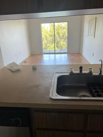 a kitchen with a sink and a window