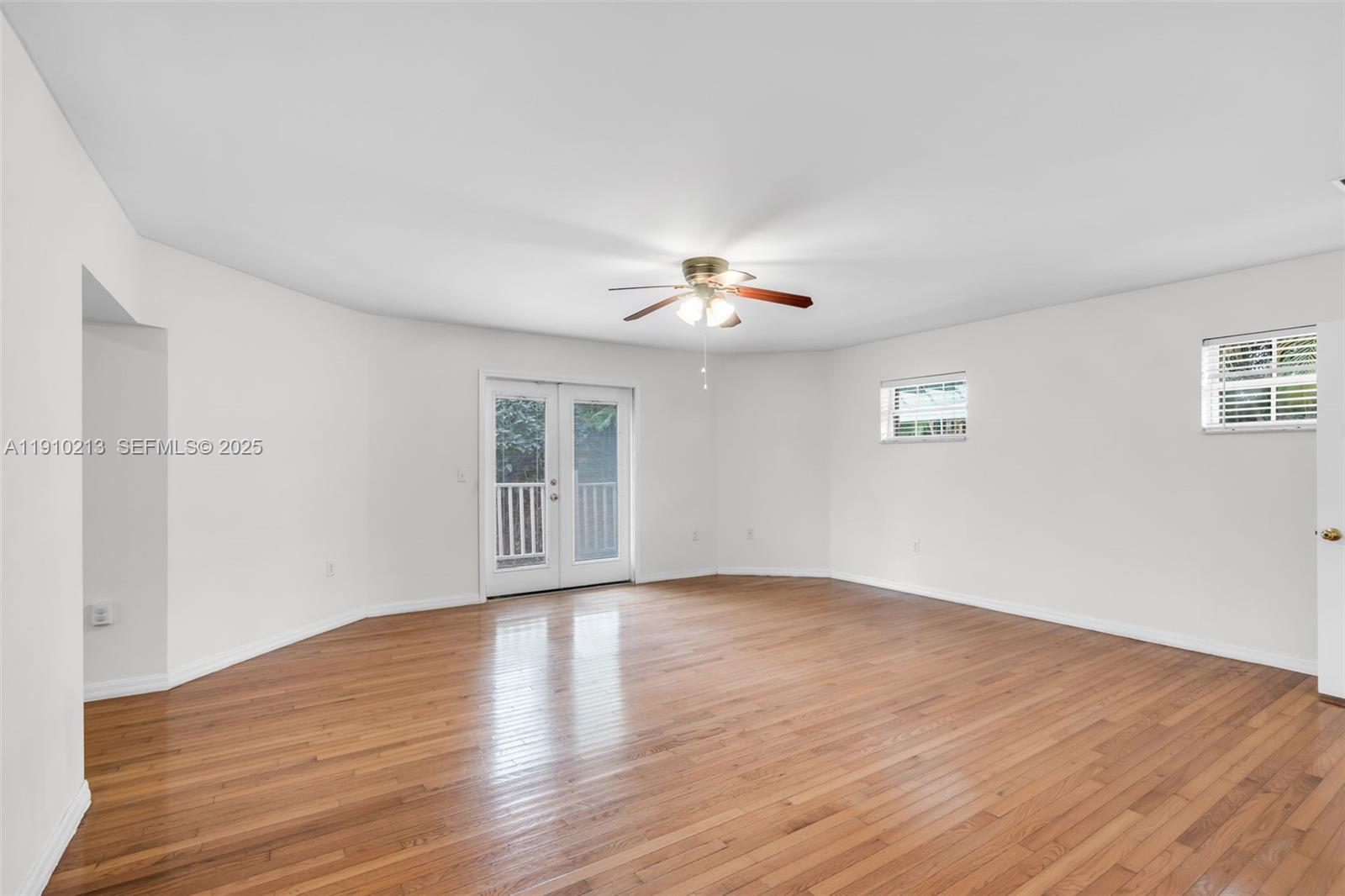 4416 Southwest 14th Street Miami, FL 33134 - Photo 12 of 33 a view of an empty room with wooden floor and a window