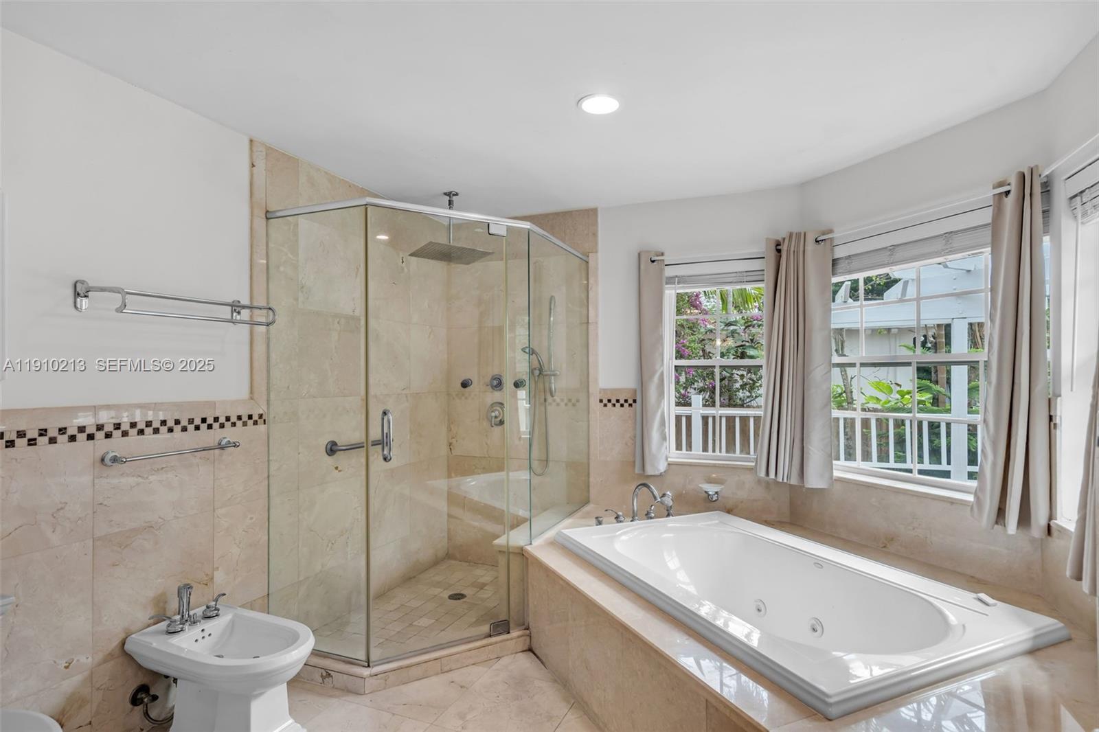 4416 Southwest 14th Street Miami, FL 33134 - Photo 16 of 33 a bathroom with a tub a toilet a sink and a large window
