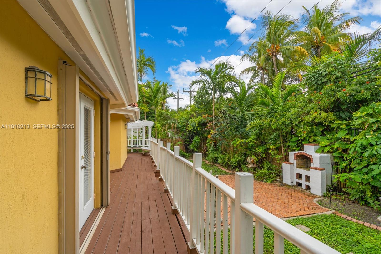 4416 Southwest 14th Street Miami, FL 33134 - Photo 25 of 33 a view of balcony with wooden floor and fence